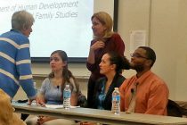 UD students (from left) Lauren Stegman, Lara Andrews and Kendall Daughtry join faculty member Bahira Sherif Trask (standing, center) for a panel discussion at the Osher Lifelong Learning Institute in Wilmington.