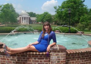 Kayla Vanderbeek poses in front of a fountain