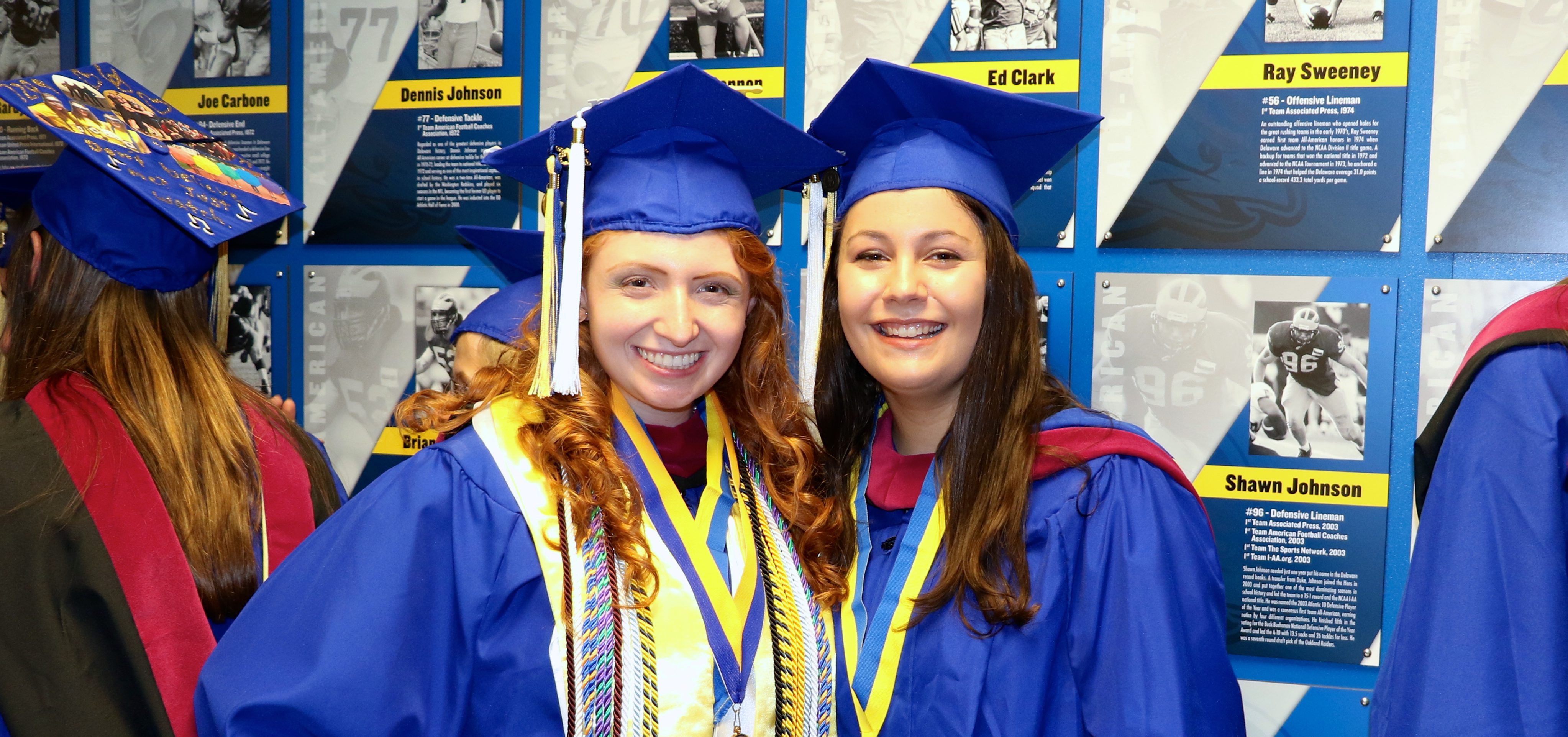 Two College of Education and Human Development students wait in line for graduation.