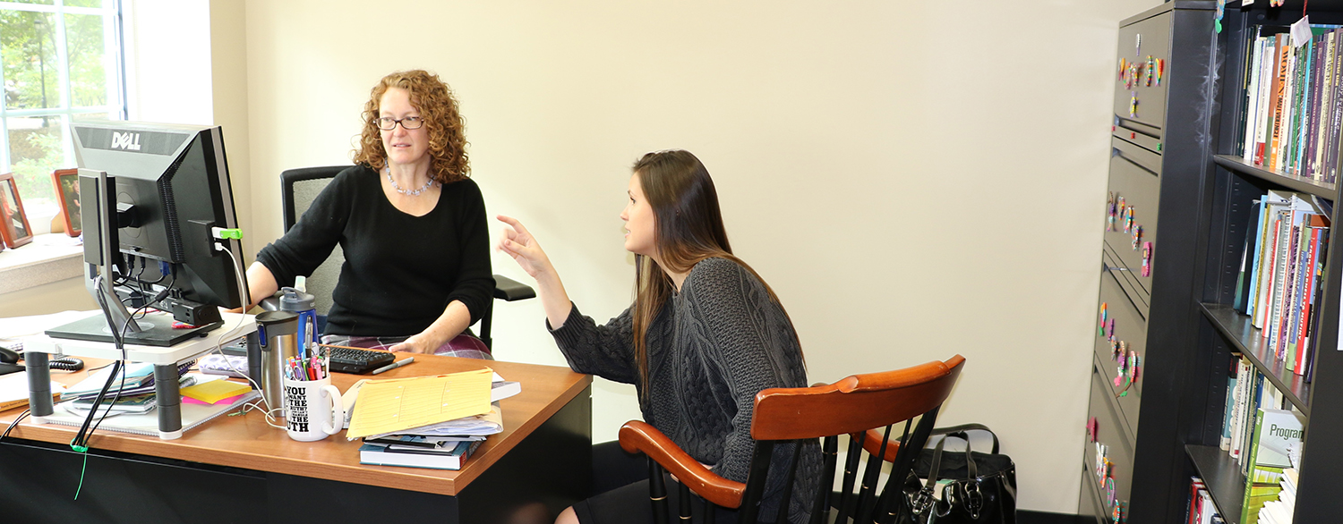 Fleury Blythe talking to student