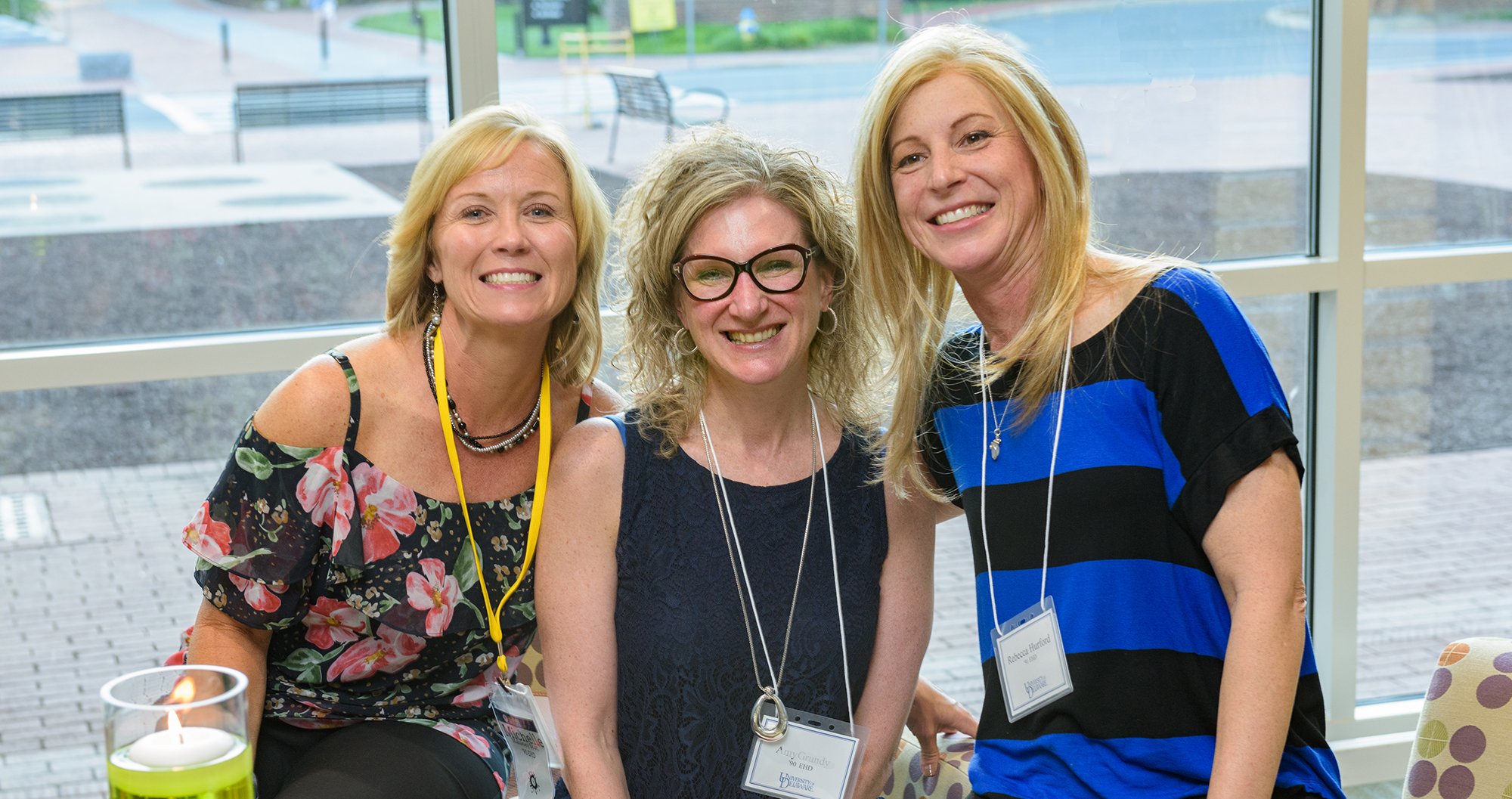 Three alumni smiling at CEHD Reception during Alumni Weekend 2017