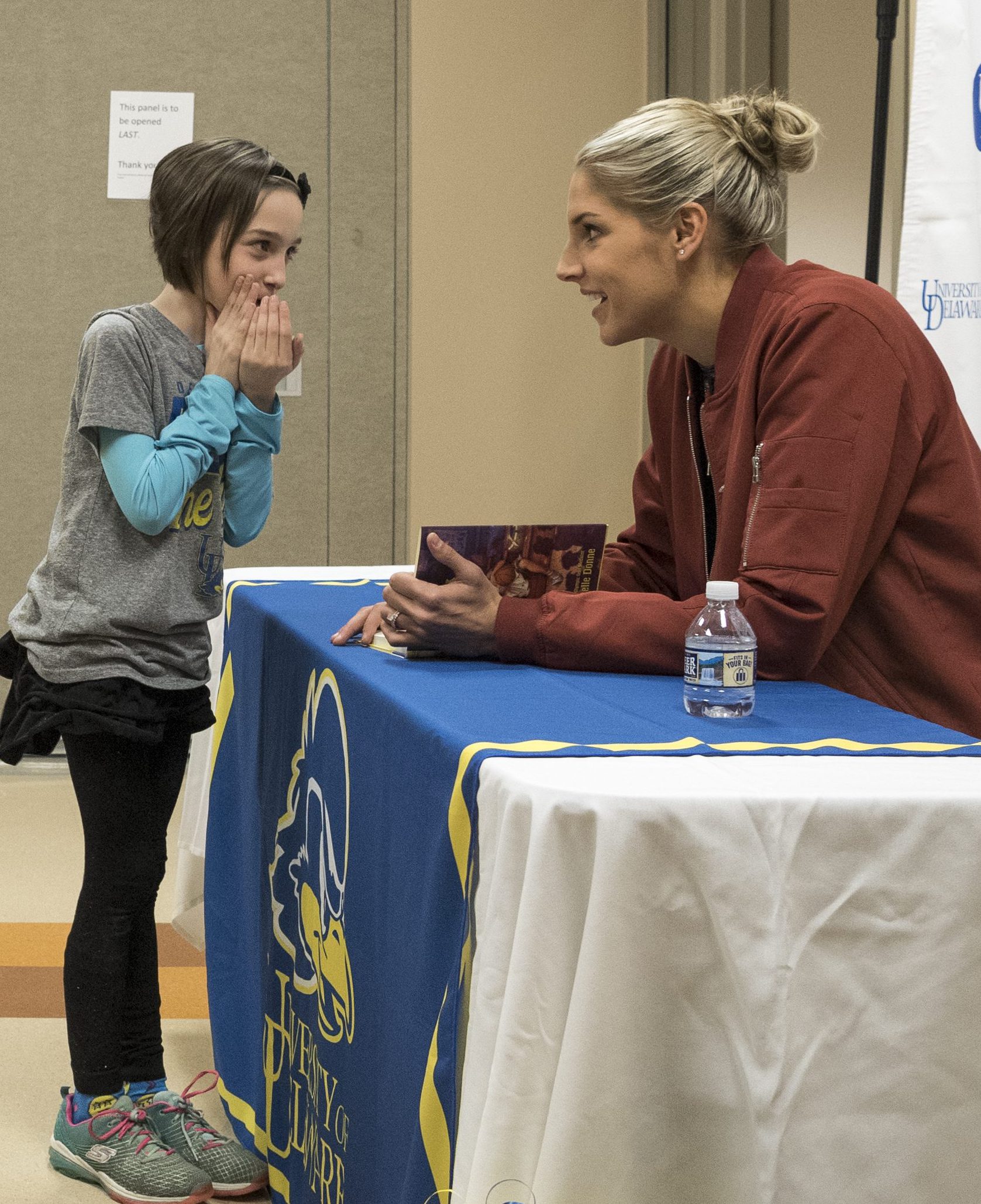 Child shares a secret with Elena Delle Donne at The College School book signing