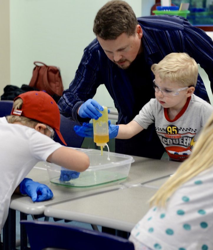 Child does a science experience on STEAM night