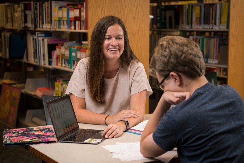 Cristina Ahrendt works with a student in the Education Resource Center
