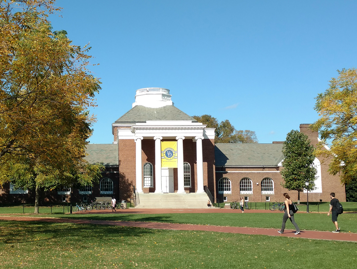 Students walk past Memorial Hall on the UD campus