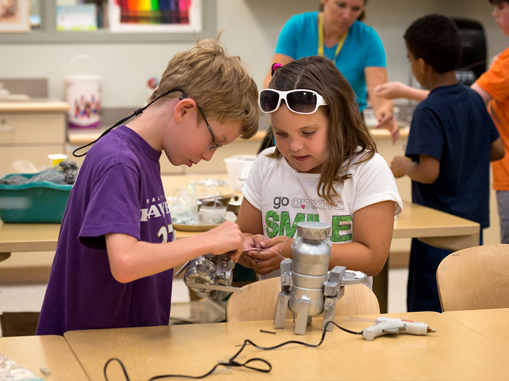 Boy and girl build robot