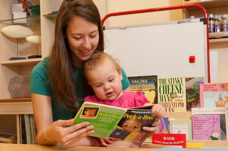 A mother and child enjoy reading together at the University of Delaware