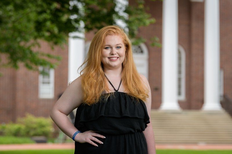 McKenna Winnie poses in front of Memorial Hall