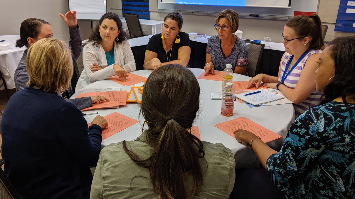 Round table of teachers having a discussion during the Bookworms Institute first session