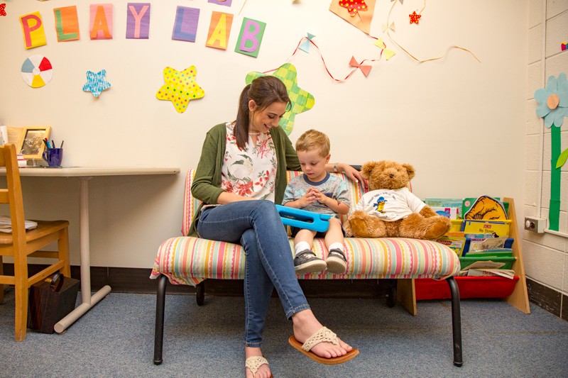 Hillary May studies a toddler at the Child’s Play, Learning, and Development Lab