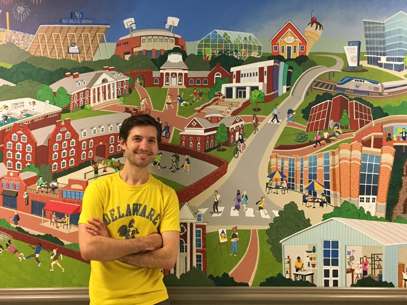 Matt Terranova poses in front of mural at The Early Learning Center