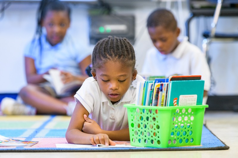 Student reading book in classroom