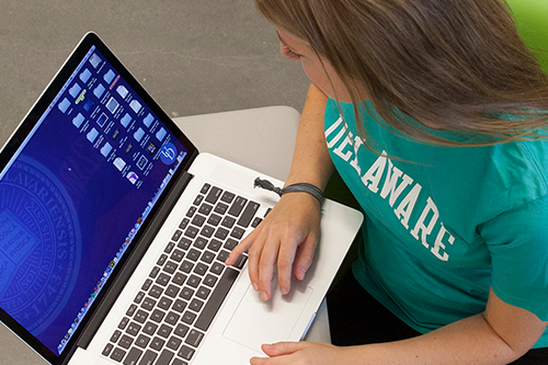 University of Delaware student on a laptop