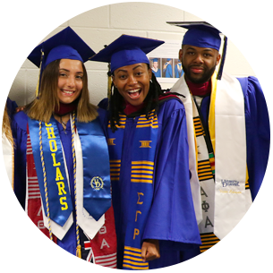 Three smiling students at the CEHD commencement ceremony