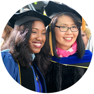 Doctoral student with faculty member at hooding ceremony