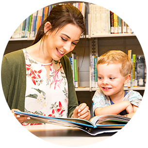 Doctoral student Hilary May reading a book with a child