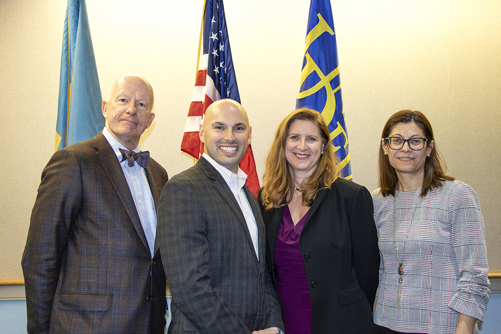 Dean Gary Henry, Laura Desimone, and Chrystalla Mouza posing with Mangone Scholar award winner Joshua Wilson