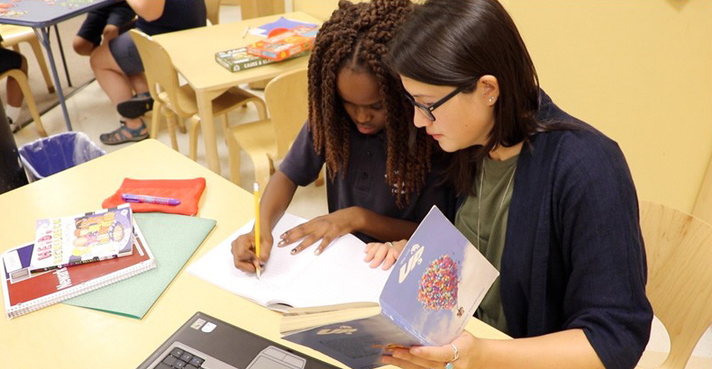 Teacher helps student with assignment