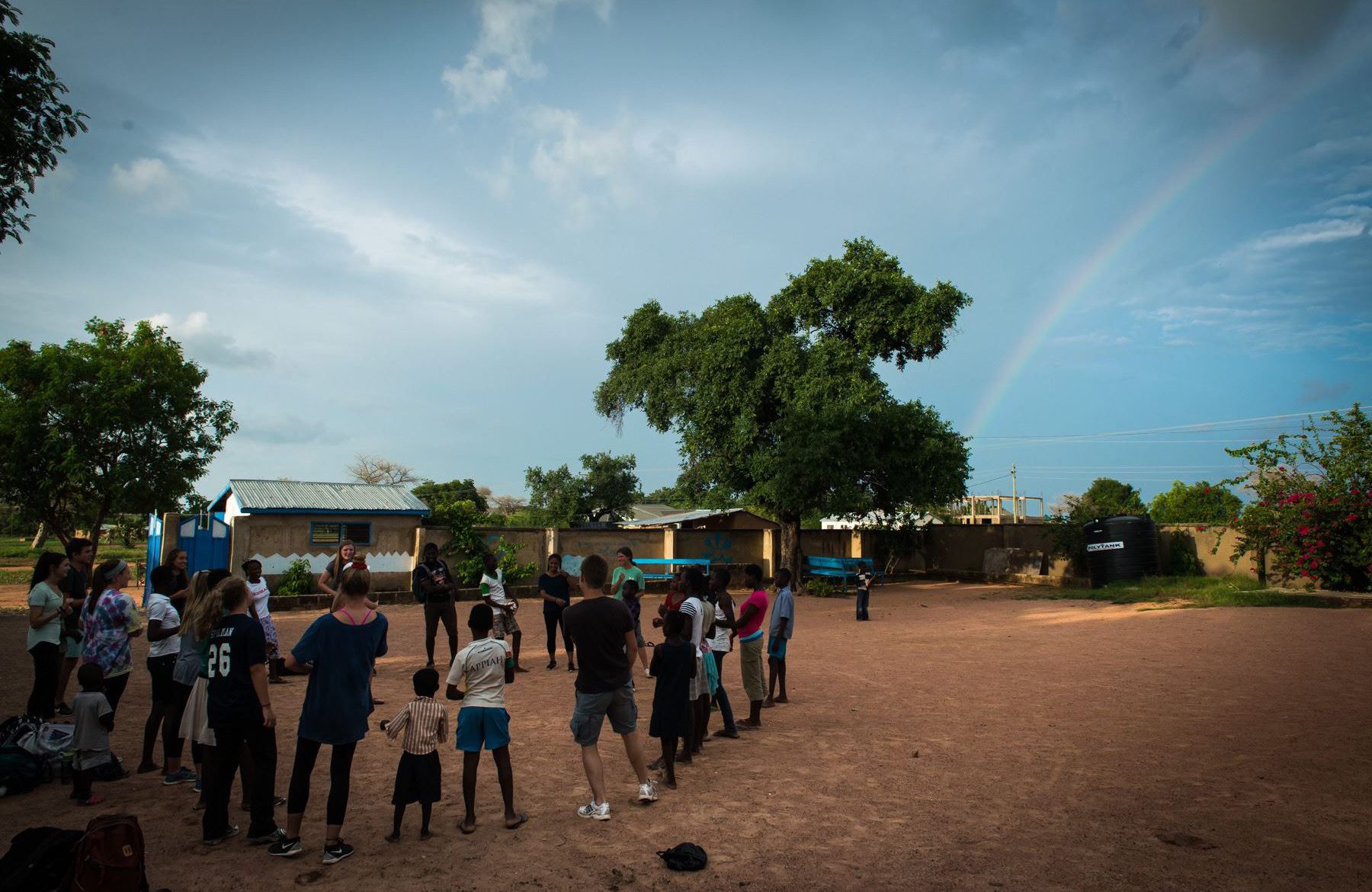 Kicking a soccer ball with school children