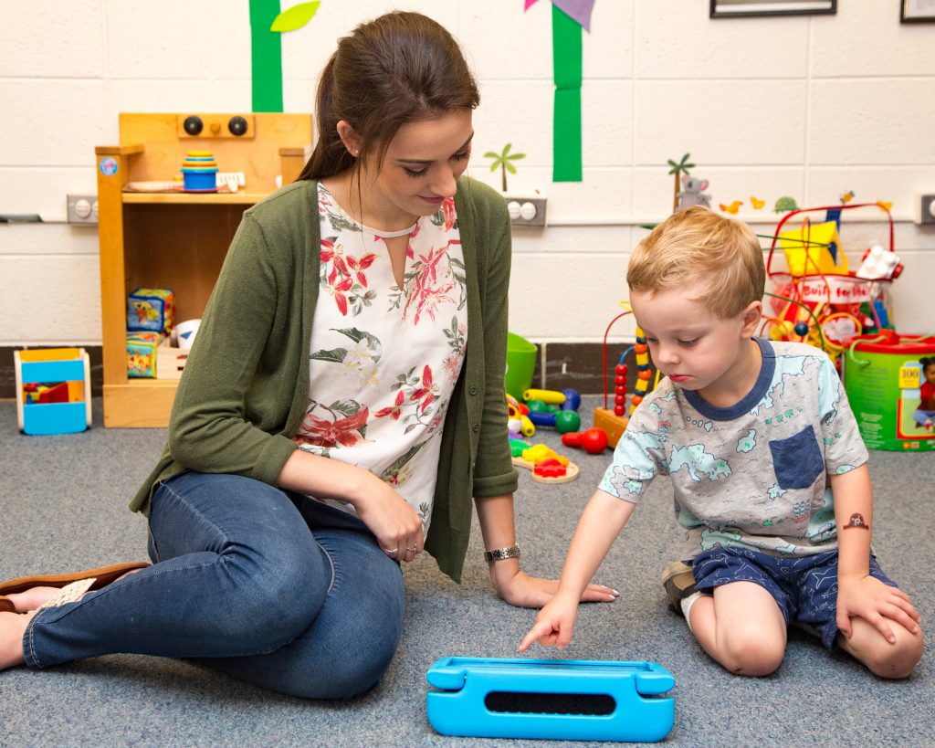 Hillary May studies a toddler at the Child’s Play, Learning, and Development Lab