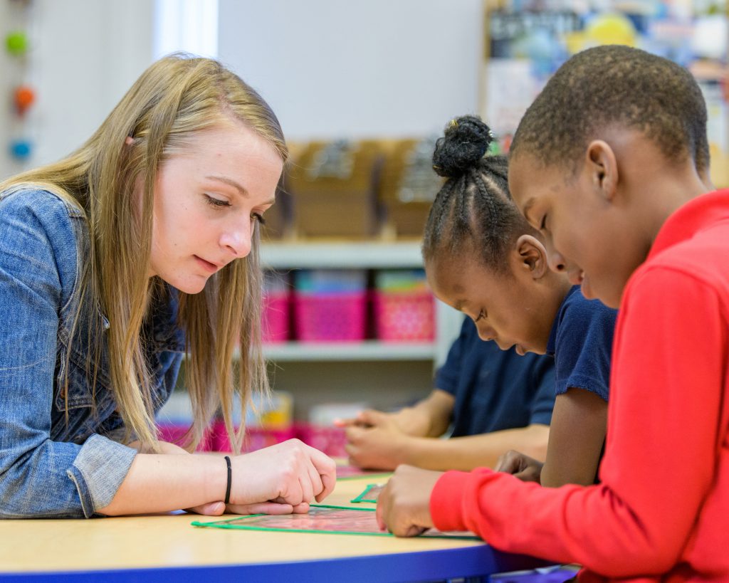 Teacher reads with two students