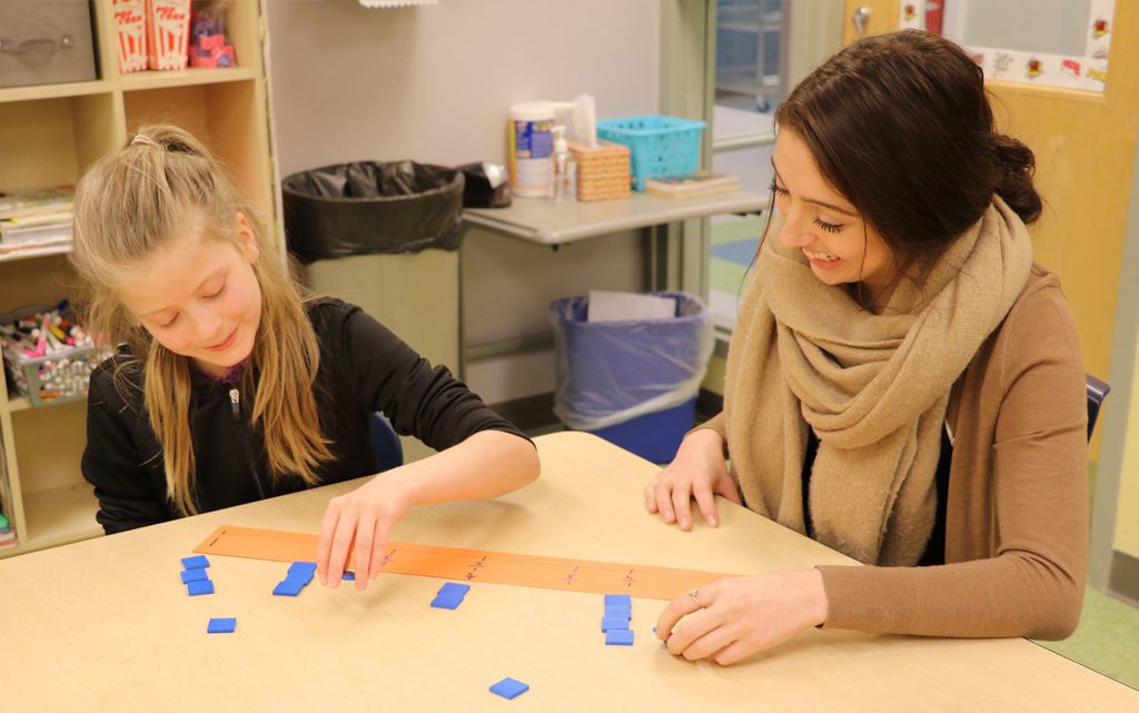 Student teaching a student with a number line