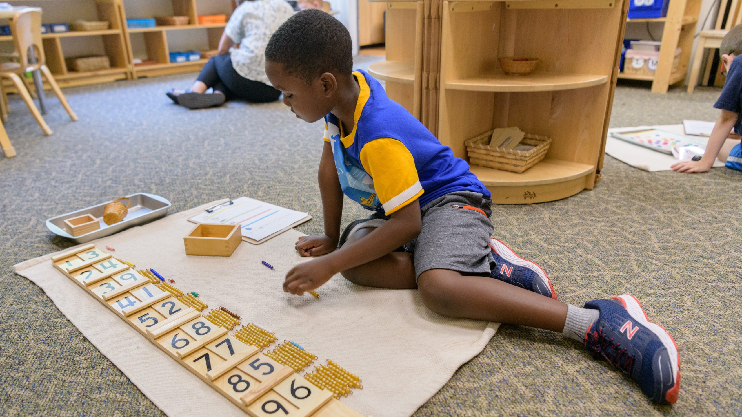 Child doing activity in Montessori classroom