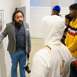 Roderick Carey speaks to a group of Black boys on a field trip to the Delaware Art Museum