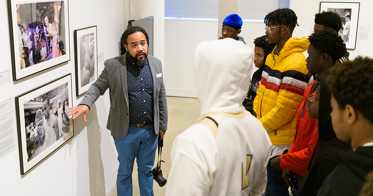 Roderick Carey speaks to a group of Black boys on a field trip to the Delaware Art Museum