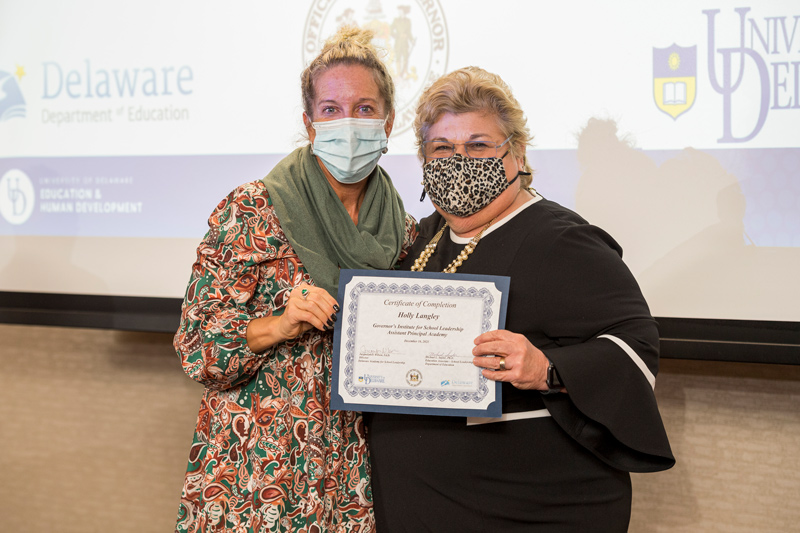 Holly Langley (left), assistant principal at Sussex Technical High School, receives her certification of completion from Jacquelyn Wilson, director of the Delaware Academy of School Leadership, after graduating from UD’s Governor’s Institute of School Leadership.