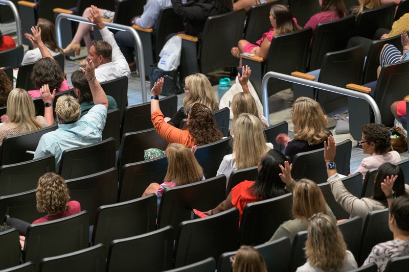 Participants actively engage during the opening session of the Policy and Practice Institute held at Dover High School.