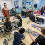 Student teacher leading a class of elementary school level students