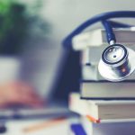 stack of books and stethoscope