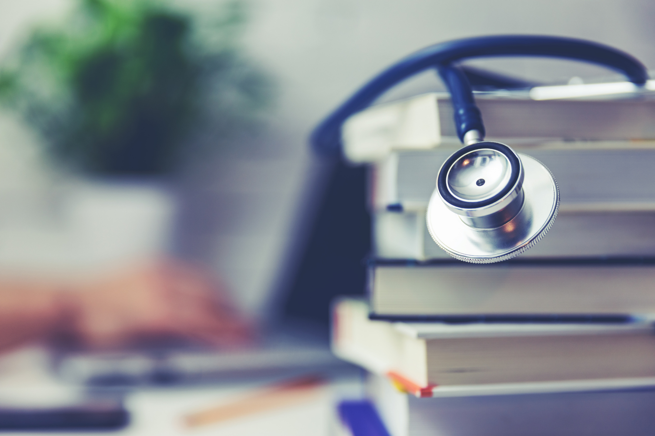 stack of books and stethoscope