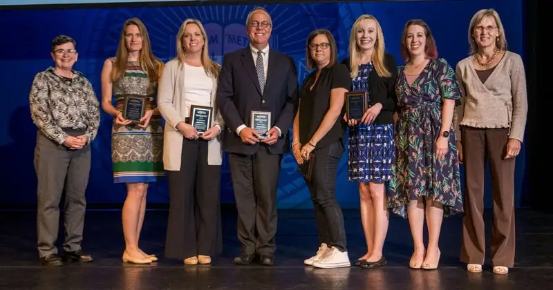 Faculty Senate President Nancy Getchell (left) and Provost Laura Carlson (right) congratulate recipients of the 2023 Excellence in Teaching Award: (from left) Stephanie Raible, Christine Hoch, Jonathan Russ, Elizabeth Soslau, Lauren Genova and Stefanie DeVito.