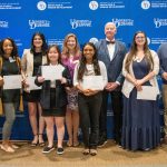 Steele award winners standing in front of UD backdrop with Dean Henry and Laura Desimone