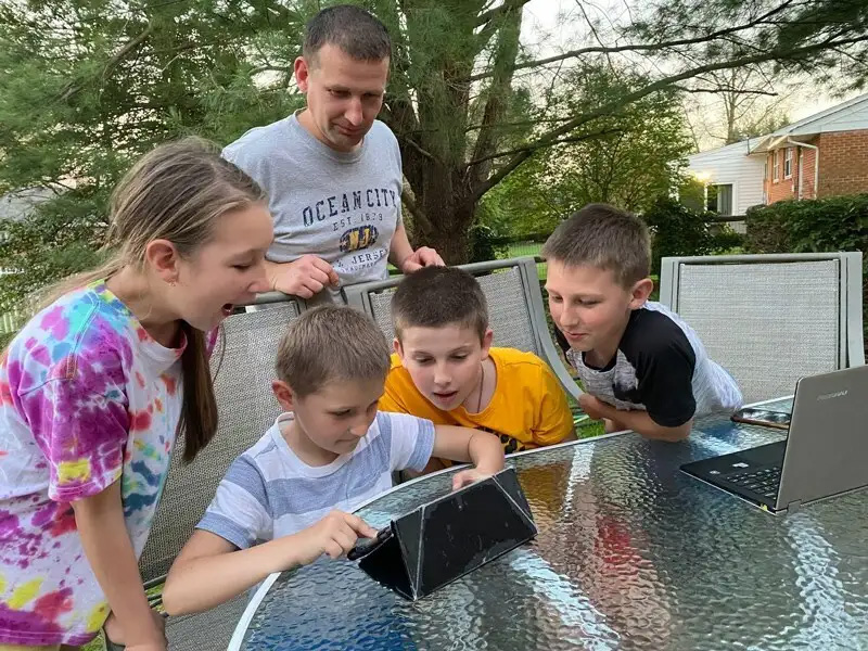 Vasyl Skrypniuk, who relocated with his family from Ukraine to Delaware, shares Stories with Clever Hedgehog with his children.