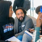 Roderick Carey speaking with high school students.