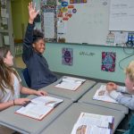 UD’s The College School specializes in teaching students with learning differences. Here, seventh grader Sanaa eagerly participates in a science lesson on divergent boundaries with classmates Katherine and Nate sharing in the group activity.