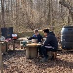 A University of Delaware student and a child interact in the Lab’s School’s outdoor mud kitchen, located on the College of Education and Human Development’s Children’s Campus.