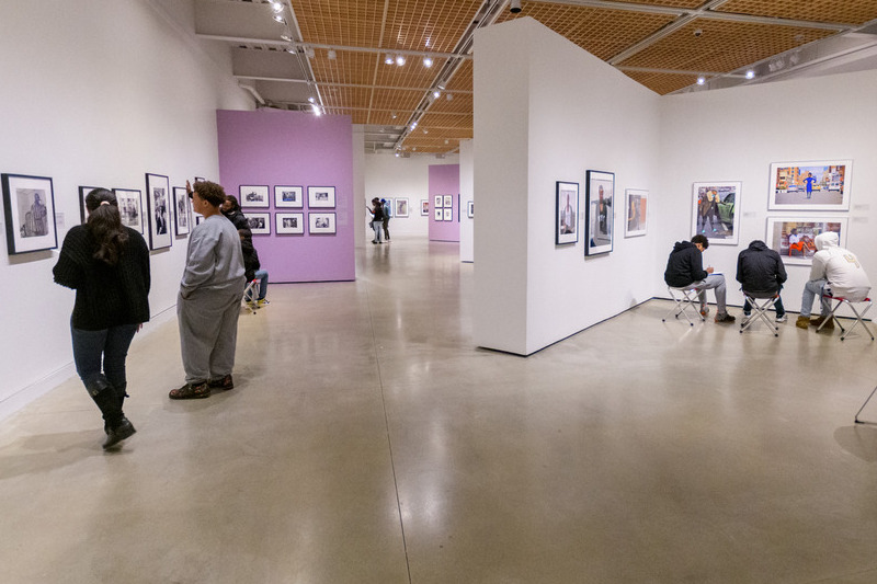 Polanco (left) walks with students participating in the Black Boy Mattering Project as they engage with art at the Delaware Art Museum.