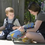A child reads with a UD student outdoors at the Lab School, housed on the College of Education and Human Development’s Children’s Campus.