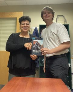 Ann Aviles and William Woelki with a copy of “Teen Runaways in America: A Reference Handbook,” which features their work.
