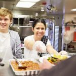Students volunteer at a community food kitchen.