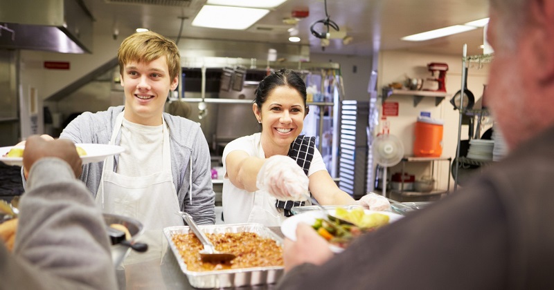 Students volunteer at a community food kitchen.