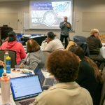Raphael Travis, CEHD professor and director of the MSW program, presents his work on the healing power of Hip Hop music at the “Global Voices in Community Wellness and Youth Violence Prevention” in March 2026.