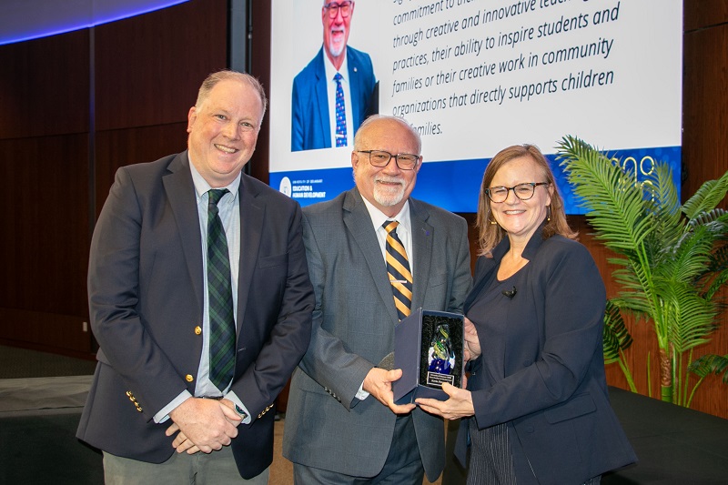 Kevin Fitzgerald (center), senior educational leadership specialist in CEHD’s School Success Center, received the 2026 Alumni Excellence in Education Award. He is pictured with Jeff Klein (left), senior policy scientist at the Center for Research in Education and Social Policy and Rena Hallam (right), interim dean.