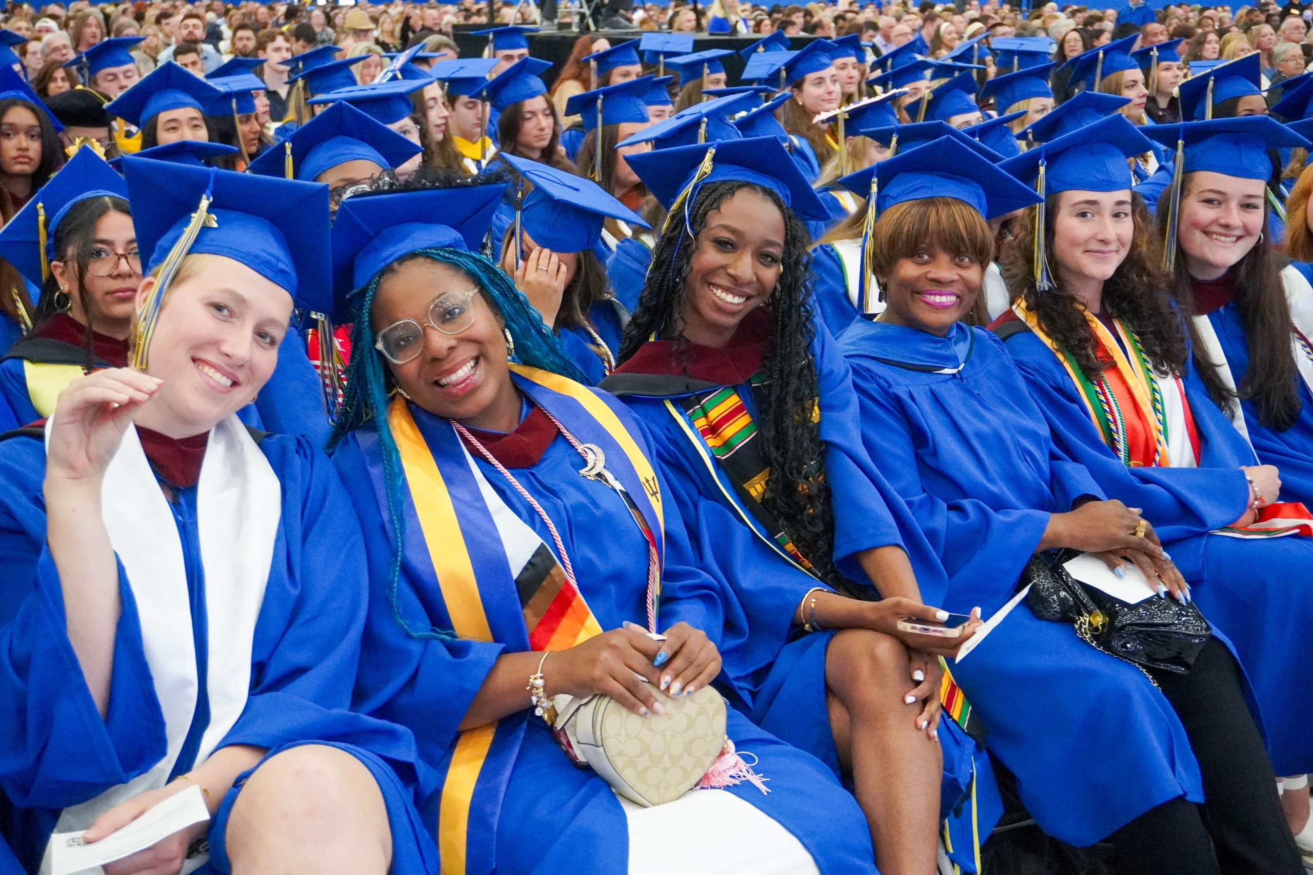 CEHD graduates, including lifelong learner Joyce Powell (third from right), wait with excitement for the moment they accept their UD degrees.