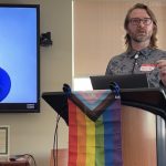 Assistant Professor Eric Layland gives opening remarks at the LGBTQ+ Research Symposium