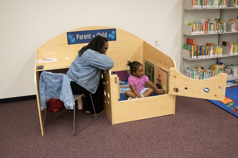 Maisha Carey and her daughter use the parent-child carrel in Morris Library’s newly opened Family Study Space.